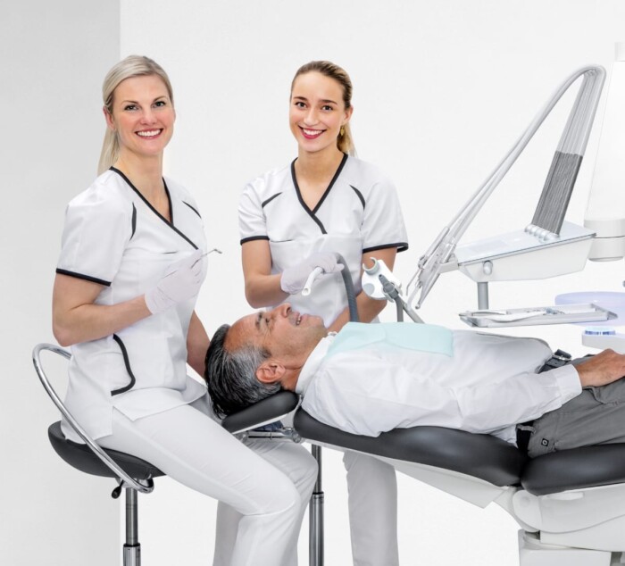 Two dentists and a patient at heka unit